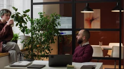 Colleagues Chatting in a Modern Office