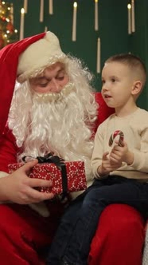 Santa Claus Giving a Gift to a Young Boy