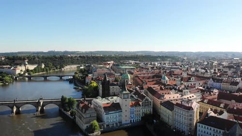 Aerial pan around the city of Praha, Czech Republic from up above the Vltava river with a view of th