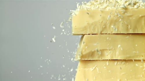 Shredded White Chocolate Falls on a Tower of Chocolate Pieces Filmed on a Highspeed Camera at 1000