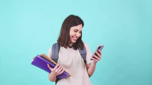 Smiling Woman with Phone and Notebooks