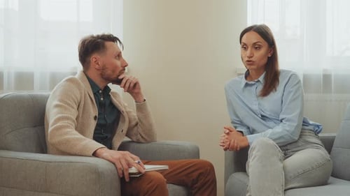 Man Listens to Woman Talking in a Therapy Session