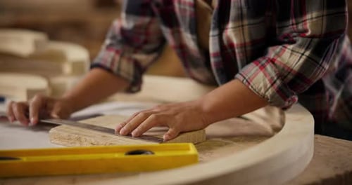 Carpenter, hands and pencil with ruler for construction notes, furniture or project plans