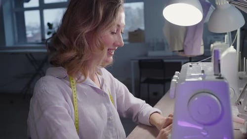 Woman Works at Sewing Machine Designer Atelier Doing Favorite Hobby Embroidering Clothes