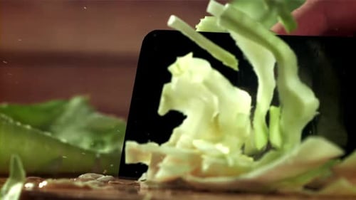 Fresh Lettuce Being Chopped on Cutting Board