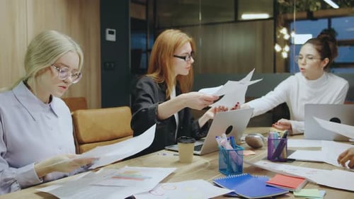 A Collaborative Meeting is Taking Place Among a Group of Businesswomen Within a Modern Office
