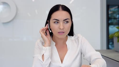 Woman Talking with Headset in Modern Office
