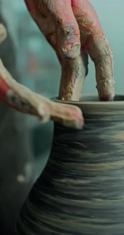 Hands Crafting Clay Vase on Potter's Wheel