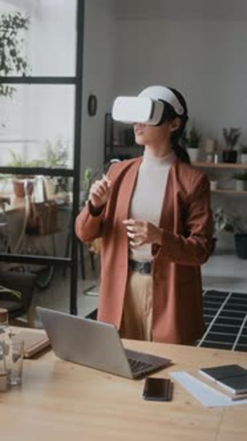 Female Software Developer in VR Headset Working in Virtual Reality in Office