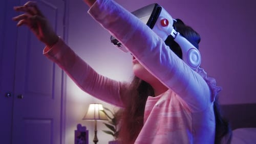 Cute Child Using Virtual Reality Headset in Bedroom