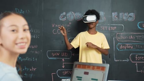 African boy using VR glasses while young woman looking at camera. Edification