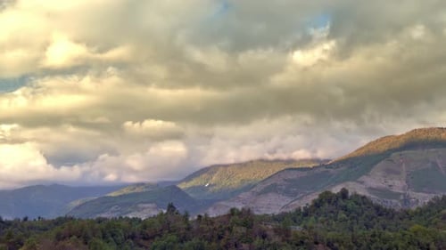 Clouds are Moving and Flying in the Sky Above Mountain Ridge Filmed in Timelapse