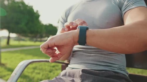 Close-up of unrecognizable young man's hands using smart watch