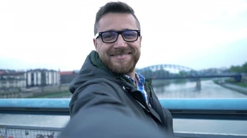 Happy Man Taking Selfie Photo and Recording Video in the City 30s