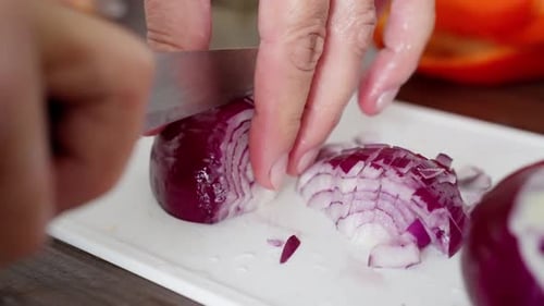 Slicing red onion with a sharp knife