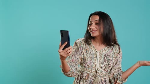 Enthusiastic Young Woman Video Chatting on a Phone