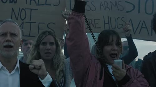 Adults Protesting with Signs and Megaphone Outdoors