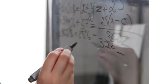 Writing Math Equations on Glass Board Close Up