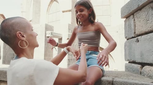 Close-up of mother talks to her daughter against the backdrop of a historic building