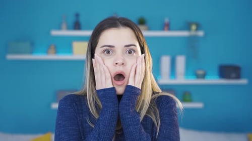 Woman Looking Shocked with Hands on Cheeks