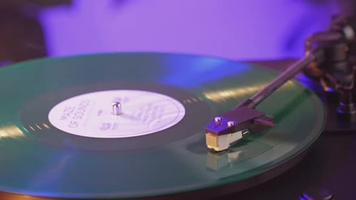 Turntable Plays Green Vinyl Record Close Up