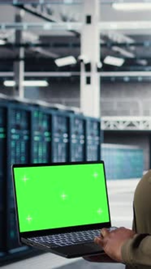 Vertical Video Server Room Admin Uses Green Screen Laptop to Upgrade Mainframes