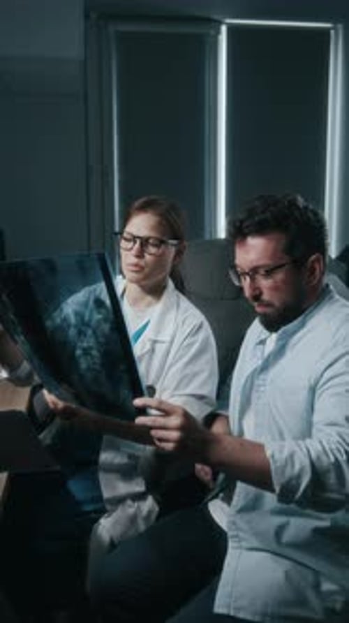 Medical professionals review patient X-ray in office