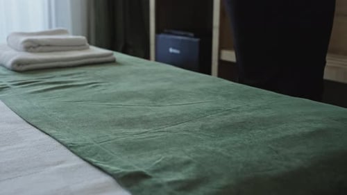 Female Hands in a Hotel Room Lay Out Fresh and Clean Towels for Guests Hotel Service Maid Prepares