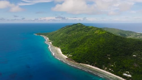 Coastal View of a Lush Island Surrounded By Turquoise Ocean Waters La Digue Seychelles