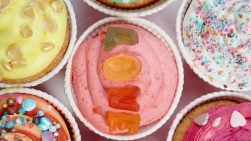 Top view of festive cupcakes decorated with jelly letters forming the word Love.