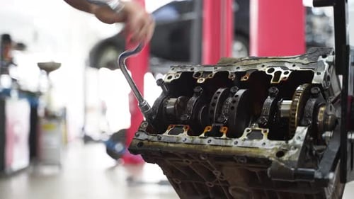 Auto Mechanic Disassembles Engine Block Removes Crankshaft at Modern Workshop for Vehicle Repair