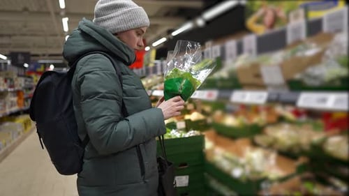 girl chooses groceries in a network grocery store, discounted goods