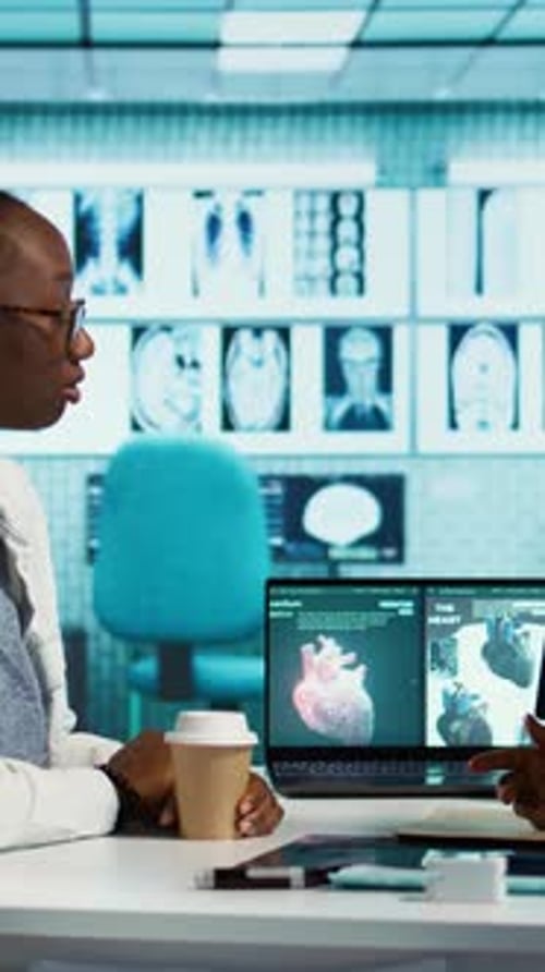 Vertikale Videoszene in einer Arztpraxis, in der ein Arzt und ein Patient die kardiologischen Testergebnisse auswerten