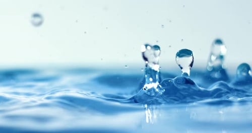 Water Droplets Splashing and Rippling in Bright Light