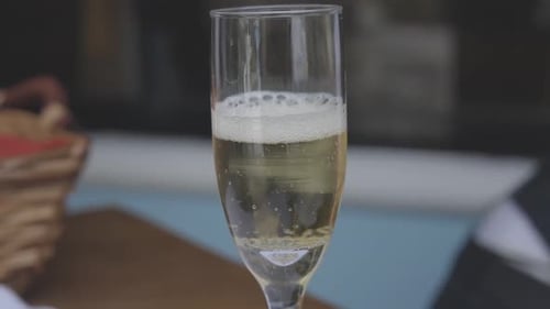 A close-up view of a champagne flute filled with bubbly drink
