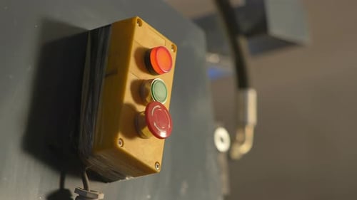 Service Technician Operating A Machine Emergency Stop Switch In A Manufacturing Factory