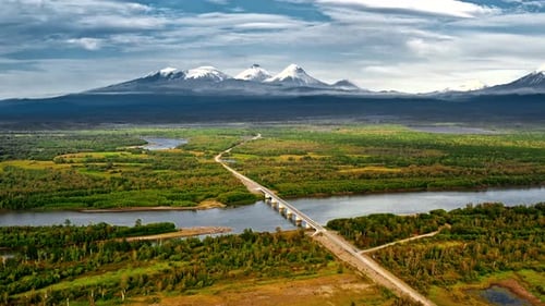 Bridge Over A River By Mountains Aerial