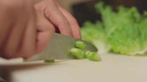 Chef's Hands Slicing Green Onion for Salad