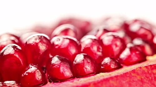 A close up of a pomegranate with many small red seeds