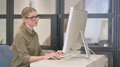 Young Businesswoman Working on Desktop in office