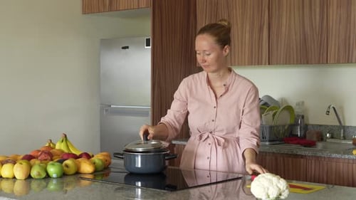 Woman Cooking With Fresh Fruit in Home Kitchen