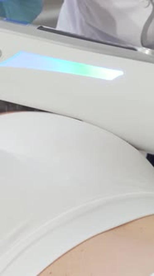 Medical Professional Using Machine on Patient