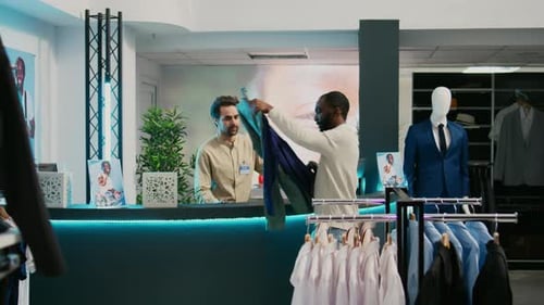 African American Client Paying for Formal Wear in Store