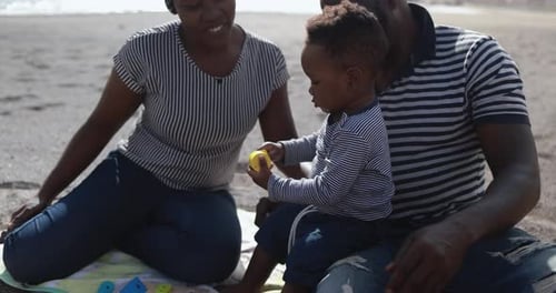 African Couple Sitting On The Beach And Having Playful Time With Little Son - Black Family Enjoy ...