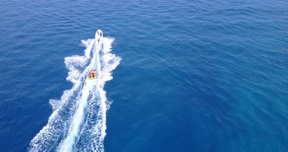 Powerboat Pulling Raft in Blue Ocean, Aerial View, Buildings Stock ...