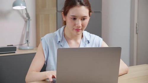 Young caucasian woman sitting and using laptop computer planning for success.