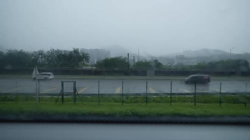 View out of foggy wet window of rainy day road with buses and cars in Hong Kong