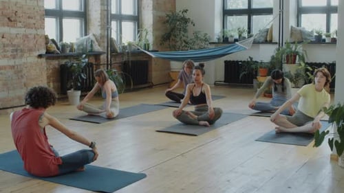 Yoga Instructor and Women Exercising in Studio