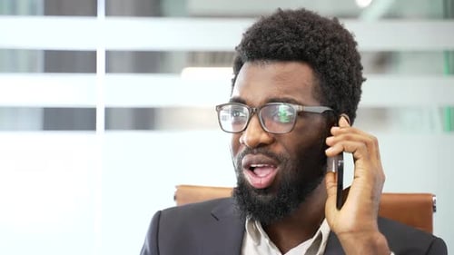 Excited Man Talking on Phone in the Office
