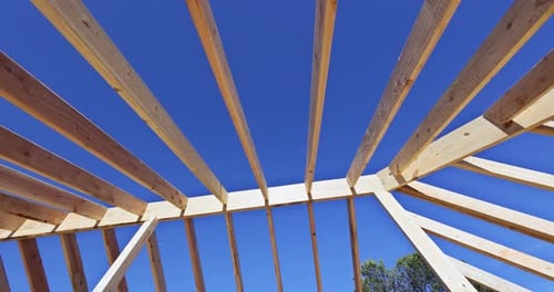 Wooden Framework of Building Against Bright Blue Sky
